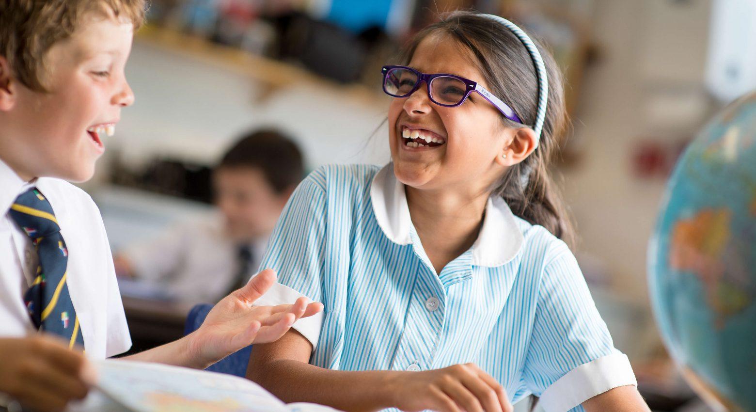 school children laughing in classroom