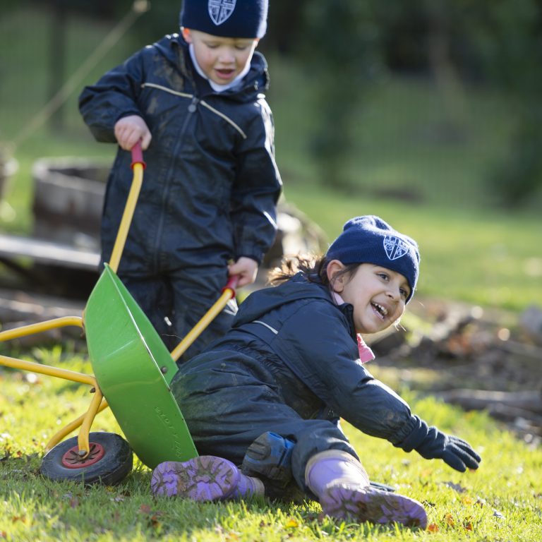 children playing with a wheelbarrow