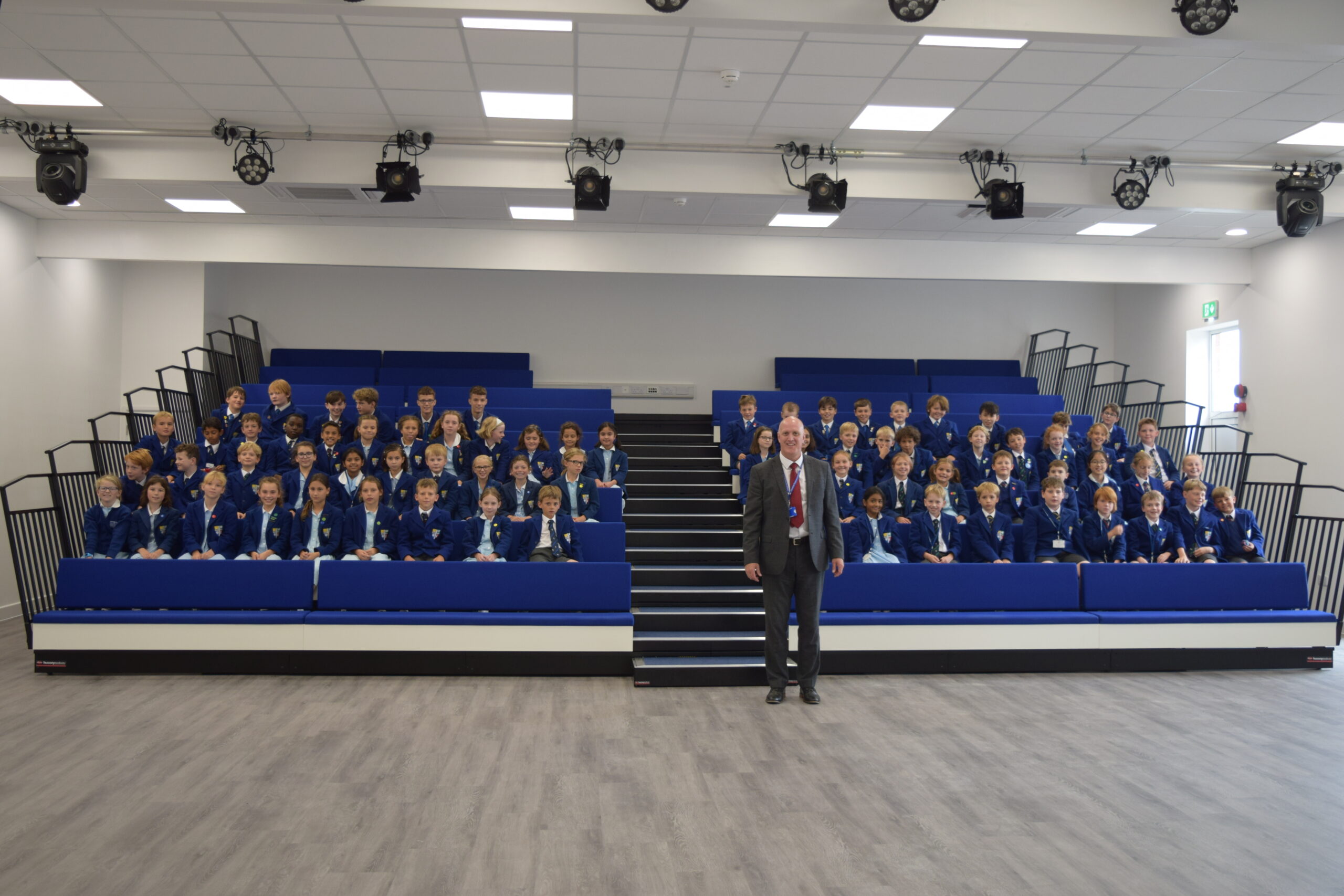 Large group of students with a teacher in the centre 